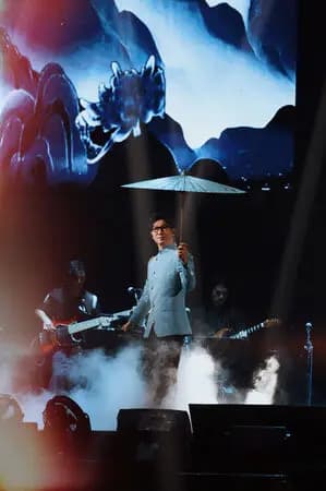 品冠手持親製油紙傘的舞台照片,圖片由種子音樂提供